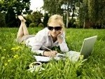 7320280-young-woman-working-outside-on-computer-and-drinking-coffee
