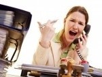7359643-businesswoman-sitting-at-her-desk-and-screaming-into-a-phone
